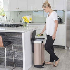 45L rectangular pedal bin with liner pocket - rose gold finish - lifestyle woman throwing stems away