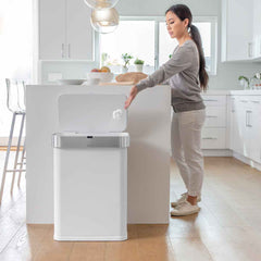 58L rectangular sensor bin with voice and motion control - white steel - lifestyle woman throwing rubbish away