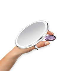 sensor mirror compact 3x - white finish - hand holding makeup image