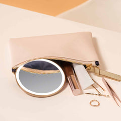 sensor mirror compact 10x - rose gold finish - lifestyle with cosmetics